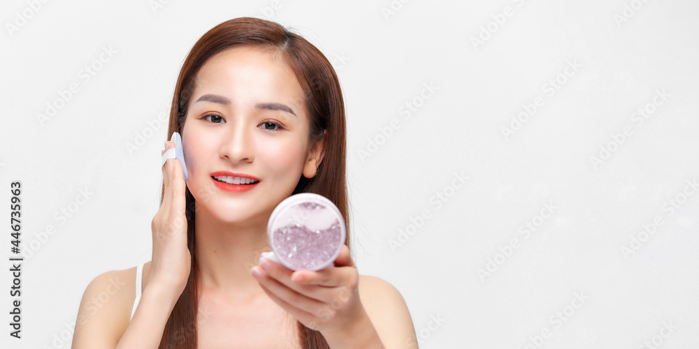 Portrait of beautiful asian woman applying powder puff at cheek makeup of cosmetic Portrait of beautiful asian woman applying powder puff at cheek makeup of cosmetic