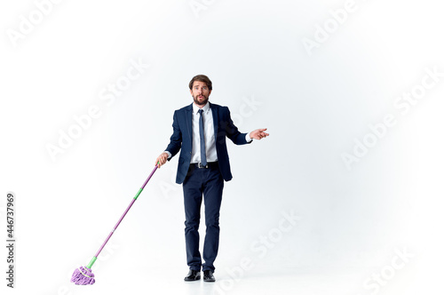 business man in a suit manager work cleaning with a mop