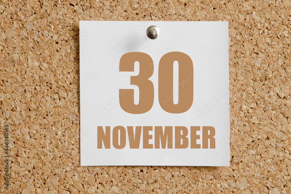 november 30. 30th day of the month, calendar date.White calendar sheet attached to brown cork board.Autumn month, day of the year concept november 30. 30th day of the month, calendar date.White calendar sheet attached to brown cork board.Autumn month, day of the year concept