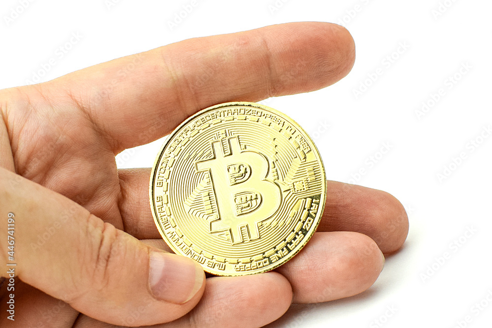 Hand holds gold bitcoin on a white background. Cryptocurrency, digital money, e-commerce. Selective focus. Hand holds gold bitcoin on a white background. Cryptocurrency, digital money, e-commerce. Selective focus.