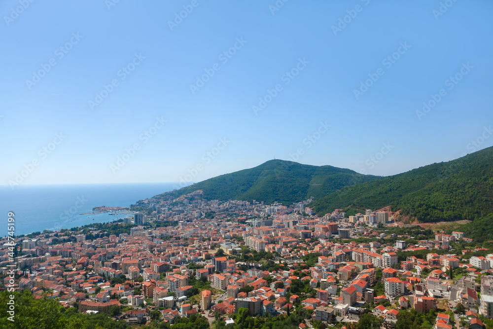 Coastal city surrounded by mountains . Panorama of Budva city in Montenegro 