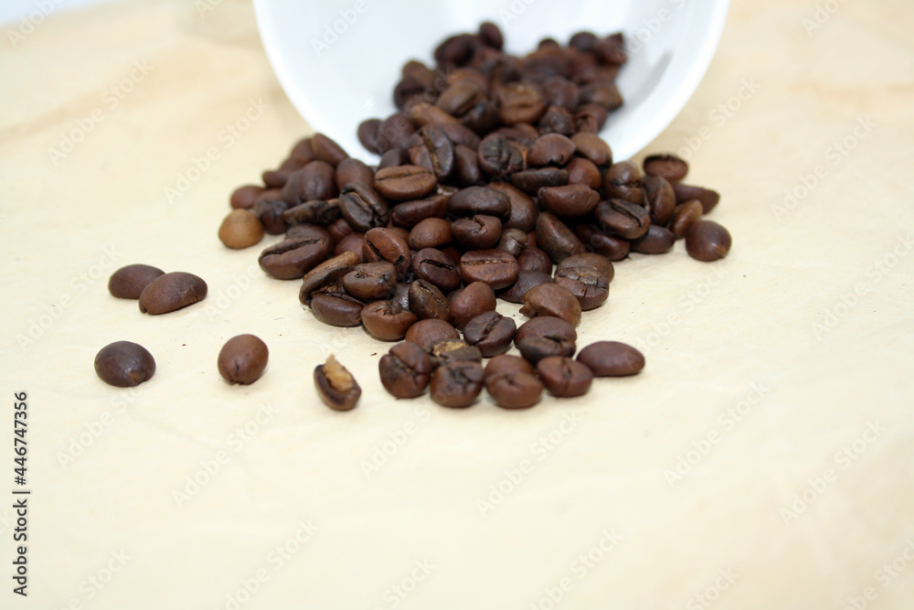 Grains of fragrant fresh coffee on craft paper. Grains of fragrant fresh coffee on craft paper.