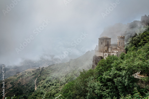 Erice Sicily Italy.Historic town on the top of mountains overlooking beautiful lush countryside.View of Venus Castle Castello di Venere  in clouds.Breathtaking panorama.Misty landscape copy space