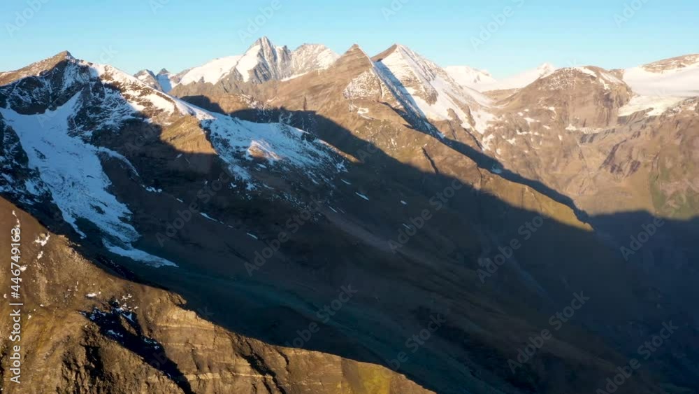 Aerial view of of Austrian Alps. Sunrise. Snowy peaks of mountains Aerial view of of Austrian Alps. Sunrise. Snowy peaks of mountains