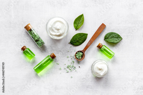 Tea tree cosmetics with essential oil and green leaves