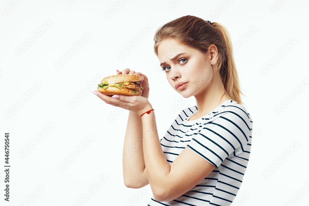 woman in striped t-shirt fast food snack junk food woman in striped t-shirt fast food snack junk food