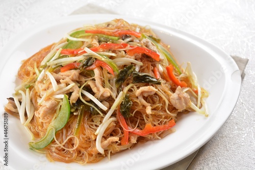 wok fried bee hoon vermicelli thin noodle with seafood and vegetables in chef dark soy sauce in white background asian halal menu