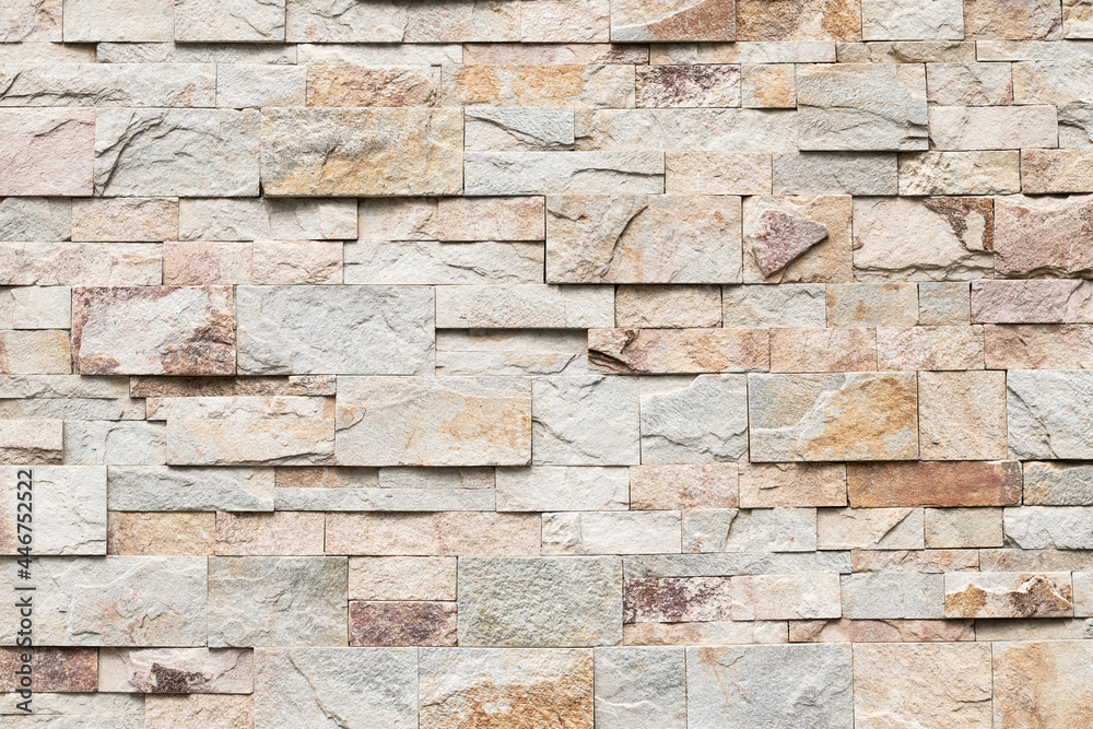 Fototapeta premium Old brick wall texture, abstract stone background. Urban brickwall, uneven rough stonewall. Beige tile, granite.