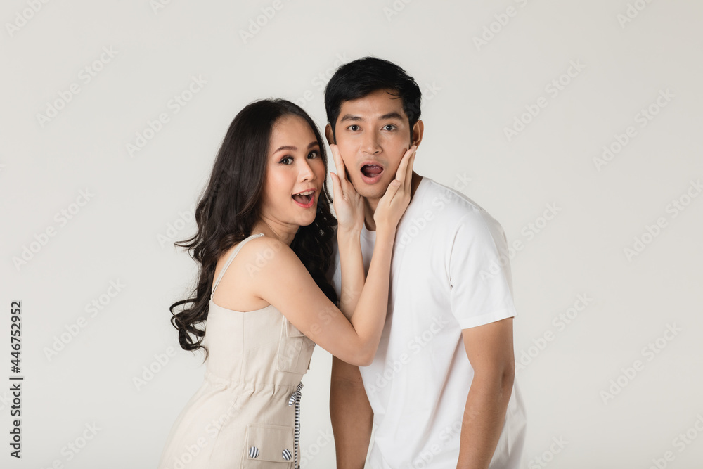 Young attractive Asian couple, man wearing white t shirt and beige pants, woman wearing beige dress. Teasing each other. Concept for pre wedding photography Young attractive Asian couple, man wearing white t shirt and beige pants, woman wearing beige dress. Teasing each other. Concept for pre wedding photography