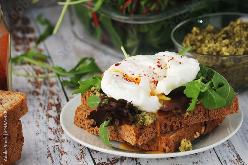 Homemade sandwiches with pesto  green salad and poached eggs