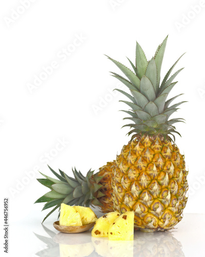 Summer fruit - Ripe pineapple with green leaves and sliced of fruit isolated on white