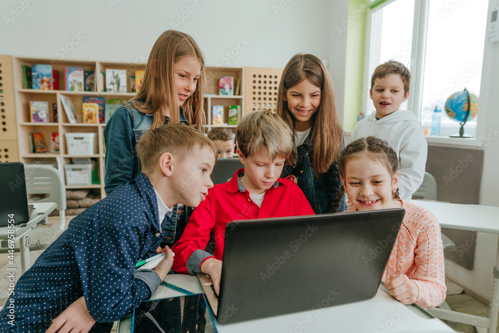 Elementary school students learning in the classroom using laptop