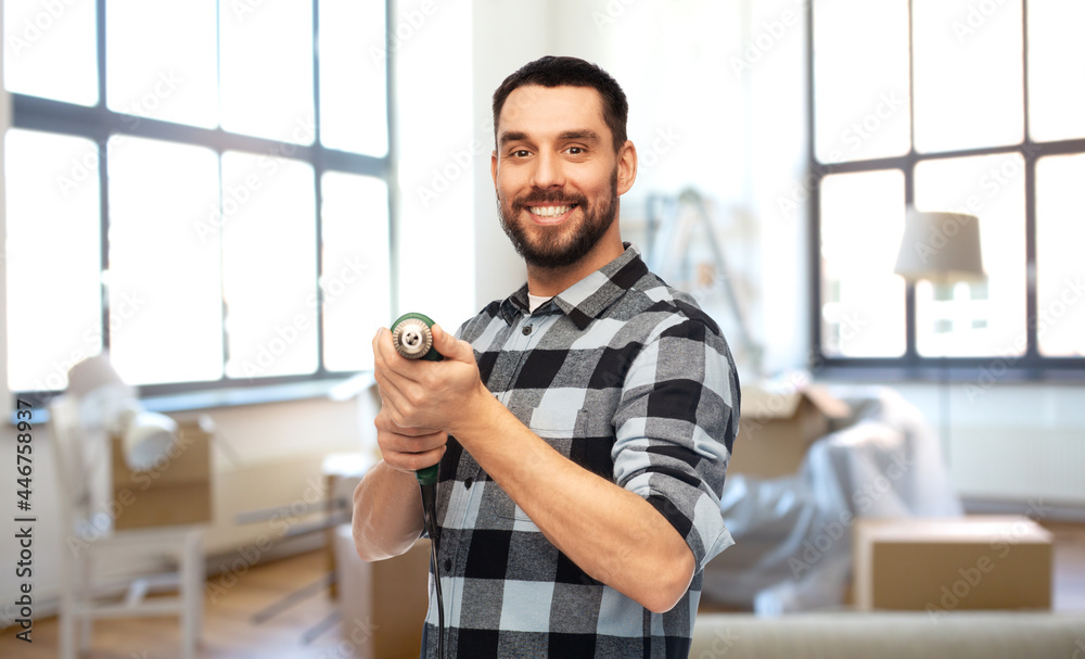 repair, construction and building concept - happy smiling man, worker or builder with drill over home room background repair, construction and building concept - happy smiling man, worker or builder with drill over home room background