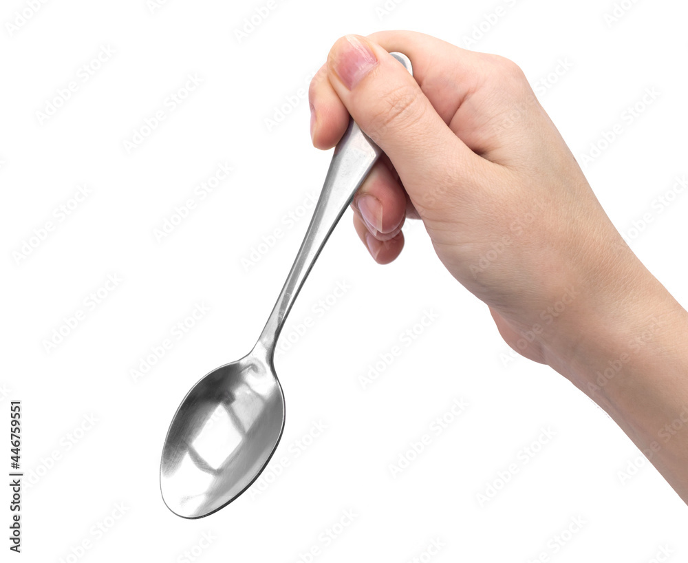 Hand holding kitchen spoon, isolated on a white background photo Hand holding kitchen spoon, isolated on a white background photo