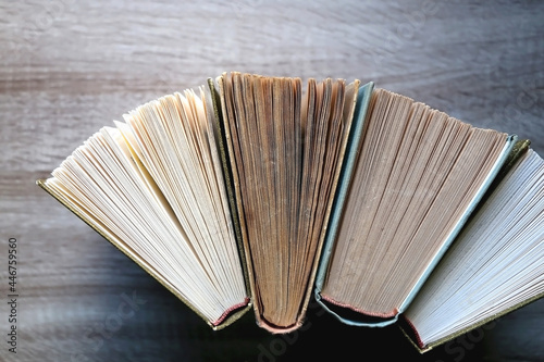 Vintage hardcover books on a wooden table. Top view.