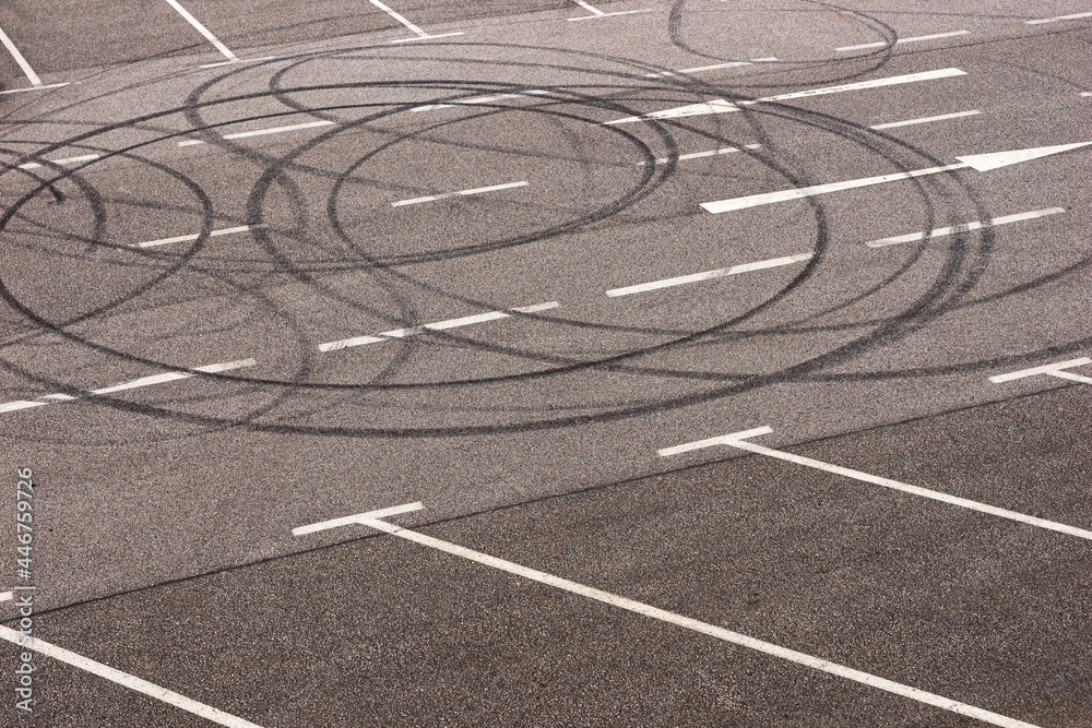 Burned tire marks in the parking lot. Donut tire tracks