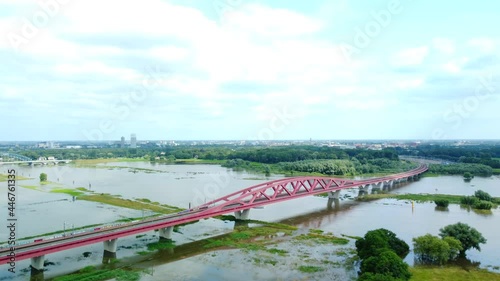 Hanzeboog train bridge with high water level on the floodplains of the river IJssel near the city of Zwolle in Overijssel during summer after heavy rainfall upstream. Aerial drone point of view. photo