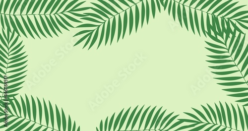 Composition of green leaves forming frame with copy space on green background