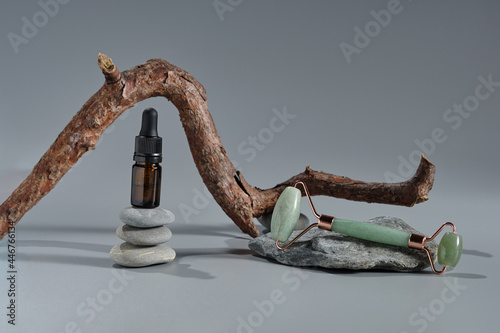Roller massagers made of jade and oil are modern tools for skin care. Modern composition with natural stones for the beauty industry