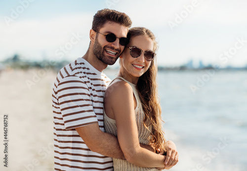 summer holidays and people concept - happy couple on beach