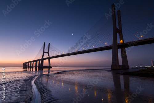 Fototapeta Naklejka Na Ścianę i Meble -  Vasco da Gama bridge over tagus river in Lisbon, Portugal, before sunrise