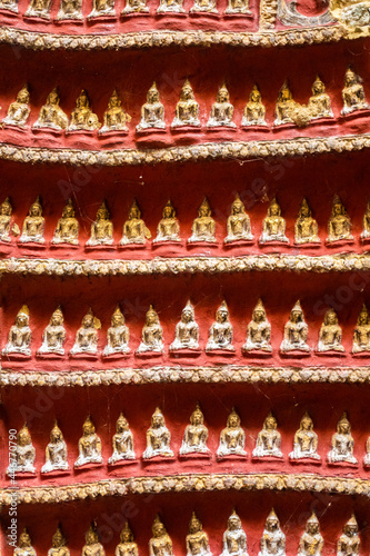 Old temple with Buddhas statues and religious carving on limestone rock in sacred Kaw Goon cave near Hpa-An in Myanmar photo