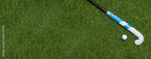 Foto Field hockey stick and ball on the green field