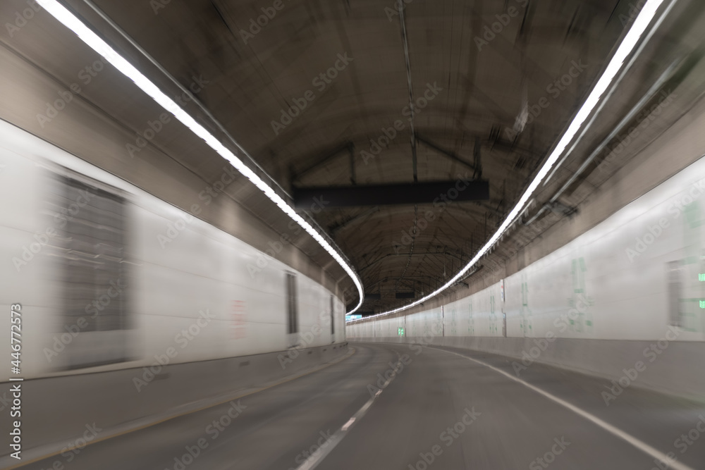 grey tunnels corridor. motion car go through illuminated way under ground. light trails.