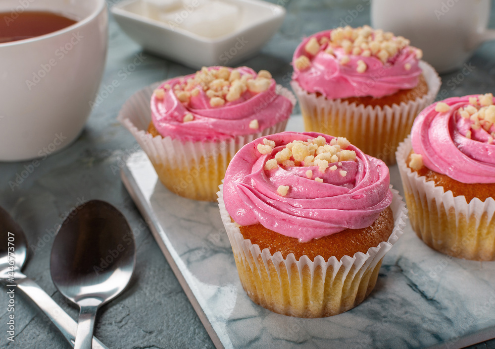 Strawberry yogurt cupcakes for tea. Sweets with tea. Strawberry sweet cupcakes.