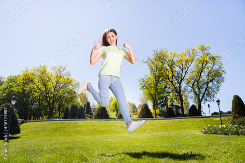 Full size photo of young girl happy positive smile show thumbs-up like fine perfect great ad jump nature outside
