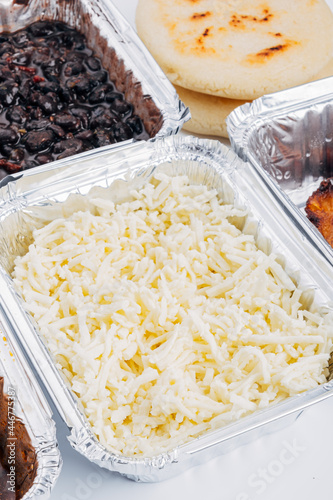 Container full of fresh white cheese ideal for filling the arepas photo