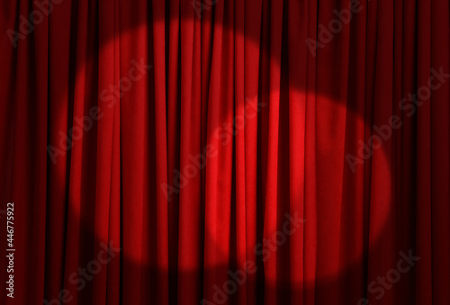 Spotlights illuminating closed red stage curtains. Start of performance