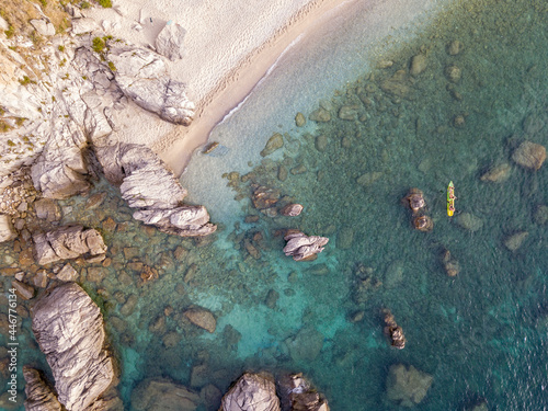Quadro em tela Aerial view of a canoe in the water floating on a transparent sea