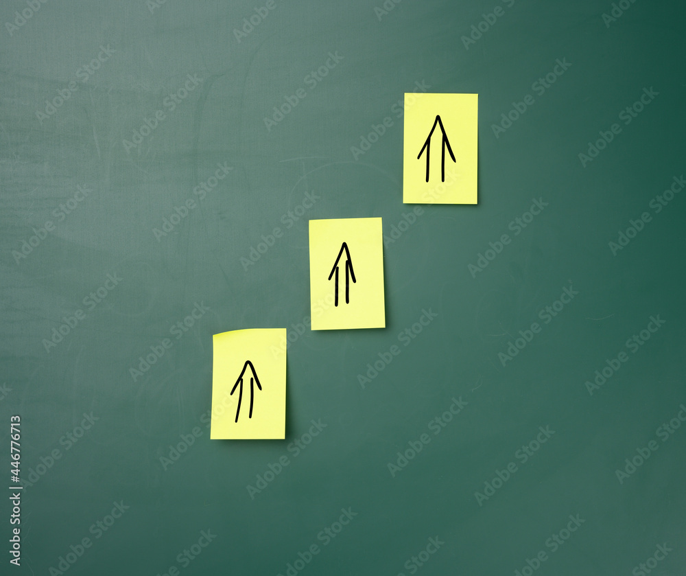 stickers on a green chalk board, drawn arrows up. Growth and dynamics concept