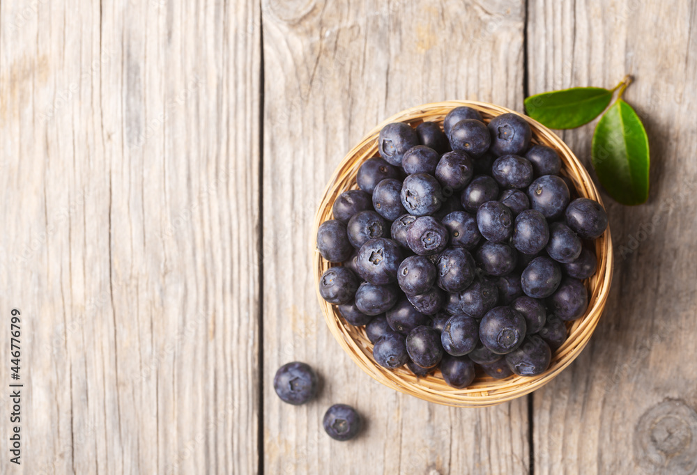 Organic blueberries in a wicker bowl with leaves Organic blueberries in a wicker bowl with leaves