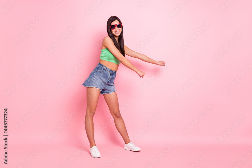 Full size photo of charming young positive woman dance slim figure smile isolated on pastel pink color background Full size photo of charming young positive woman dance slim figure smile isolated on pastel pink color background