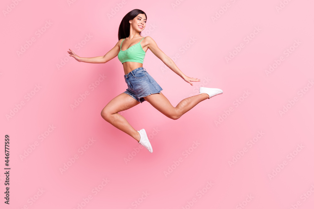 Full size photo of positive happy woman look empty space jump dancer isolated on pastel pink color background