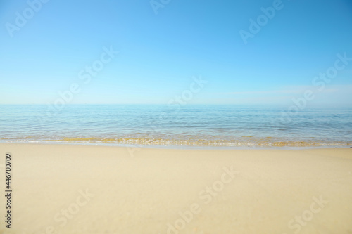 Beautiful sandy beach and sea under blue sky, closeup