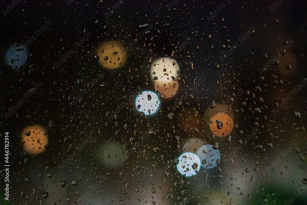 Water drops, city lights on the glass at night, bokeh, background Water drops, city lights on the glass at night, bokeh, background