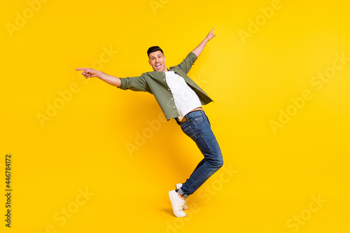 Full length body size view of attractive cheerful crazy foolish childish guy dancing having fun isolated over bright yellow color background