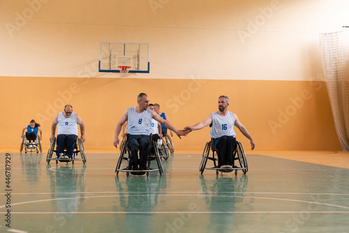 a team of war veterans in wheelchairs playing basketball, celebrating points won in a game. High five concept