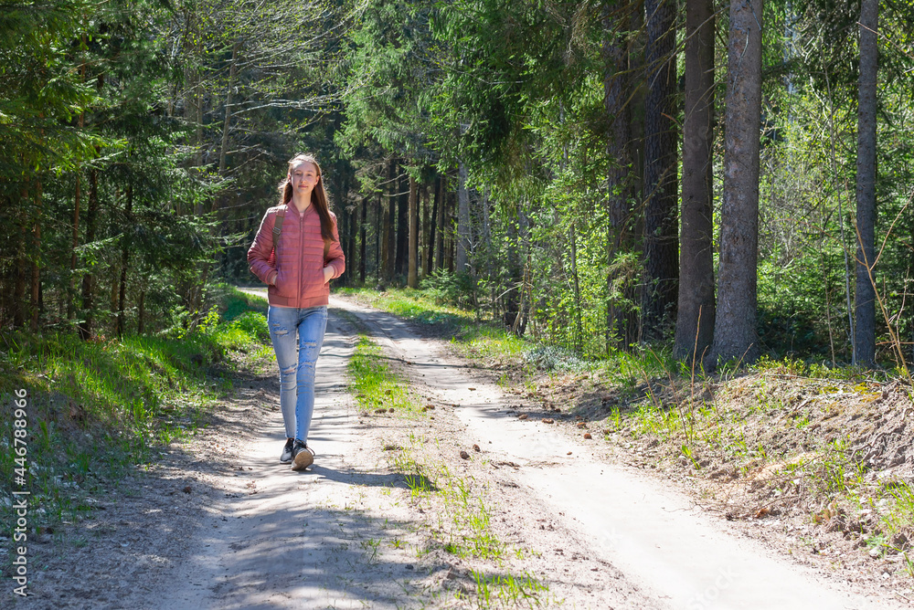 Lonely one girl walk in the road forest summer spring background, Relax time on holiday concept travel. Lonely one girl walk in the road forest summer spring background, Relax time on holiday concept travel.