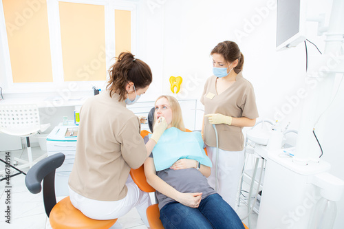 pregnant woman at the dentist's office, checkup and dental treatment for pregnant women.