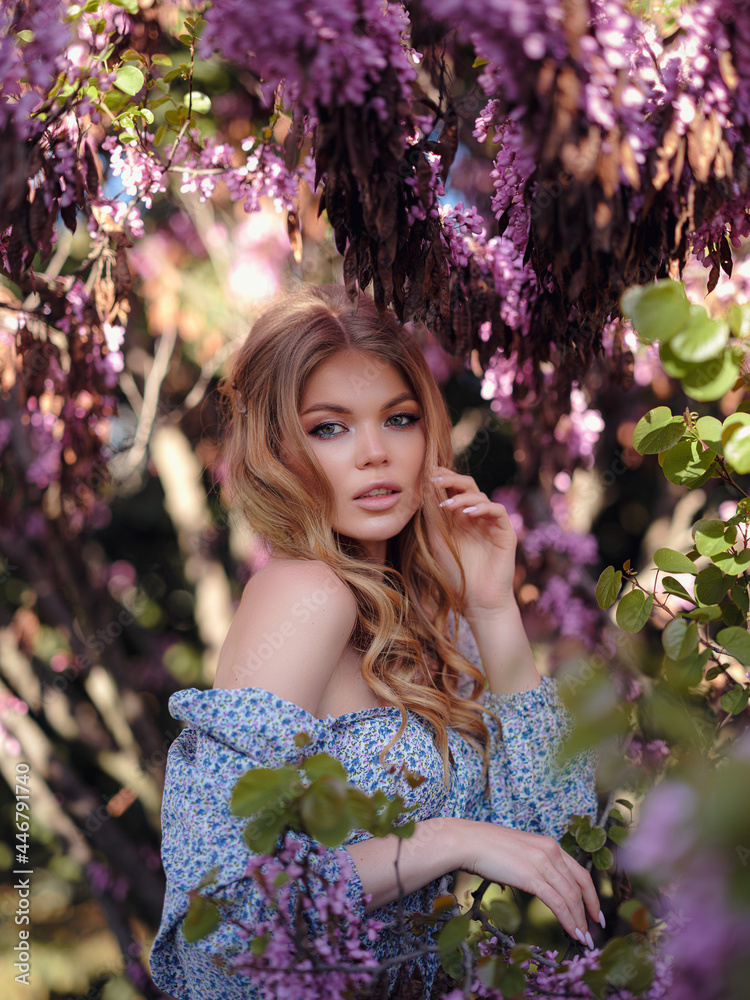 Fototapeta premium a young woman walking in an evening summer city