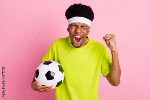 Photo of happy positive dark skin man winner match hold football player isolated on pink color background © deagreez