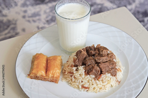 A traditional Kurban Bayram meal in Turkey. Braised meat served with rice, Baklava and Ayran drink.