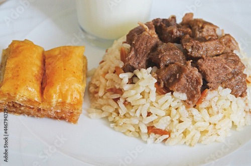 A traditional Kurban Bayram meal in Turkey. Braised meat served with rice, Baklava and Ayran drink.