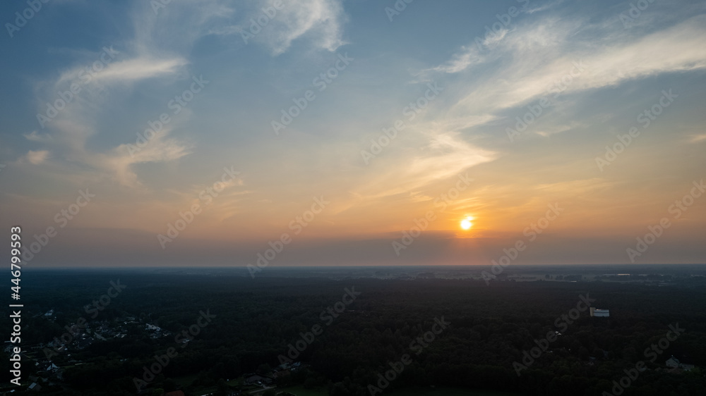 Colorful sky background sunset, illuminated pink-orange dramatic clouds, aerial photography, far horizon, setting sun. Ideal for sky replacement postproces. High quality photo