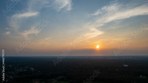 Colorful sky background sunset, illuminated pink-orange dramatic clouds, aerial photography, far horizon, setting sun. Ideal for sky replacement postproces. High quality photo