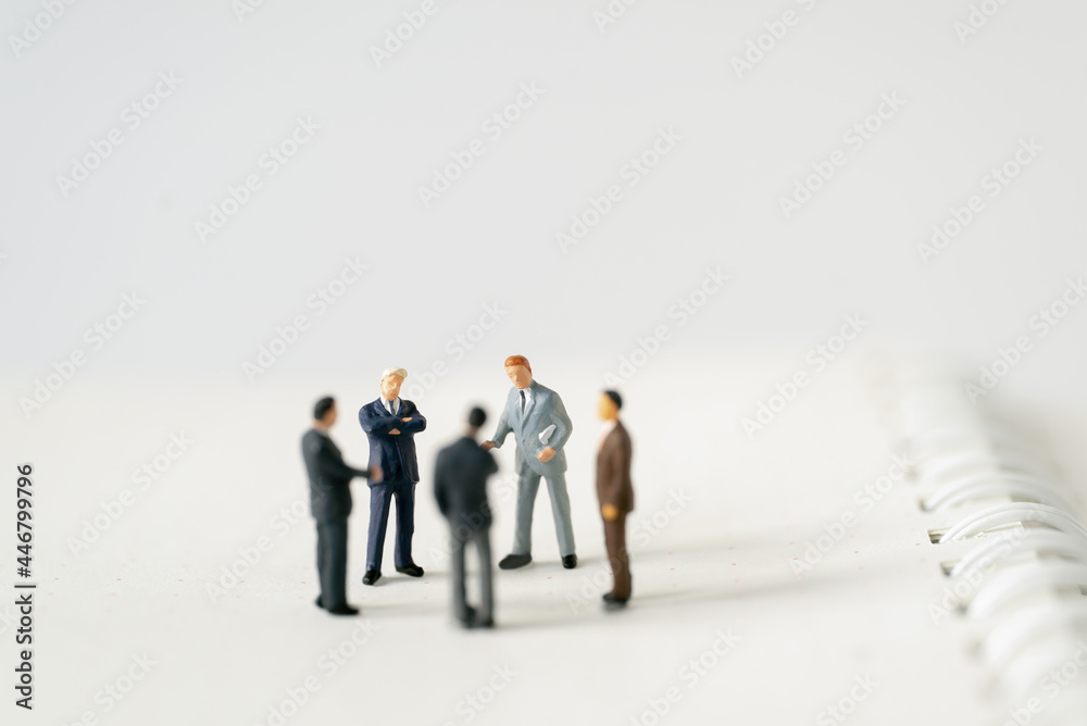 Miniature businessman planning thinking success deal business on white background using as commitment, insurance agreement, travel investment and partnership business development joint venture concept